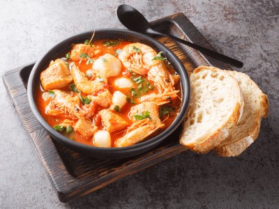 Brudet - This fish stew is made in a variety of ways, but most traditionally with white fish, seafood stock, vegetables, tomato, red/white wine, vinegar, and spices.