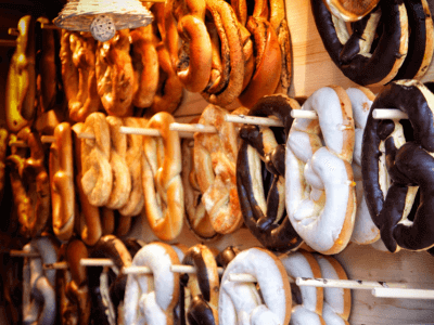 Image of Brezel in german bakery, made from dough, boiled, baked, and topped with salt, seeds, or cheese, and served with a mustard dip.