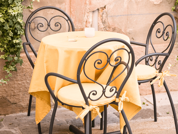 a image of a table at restaurant in italy with a yellow table cloths eating shellfish free in italy