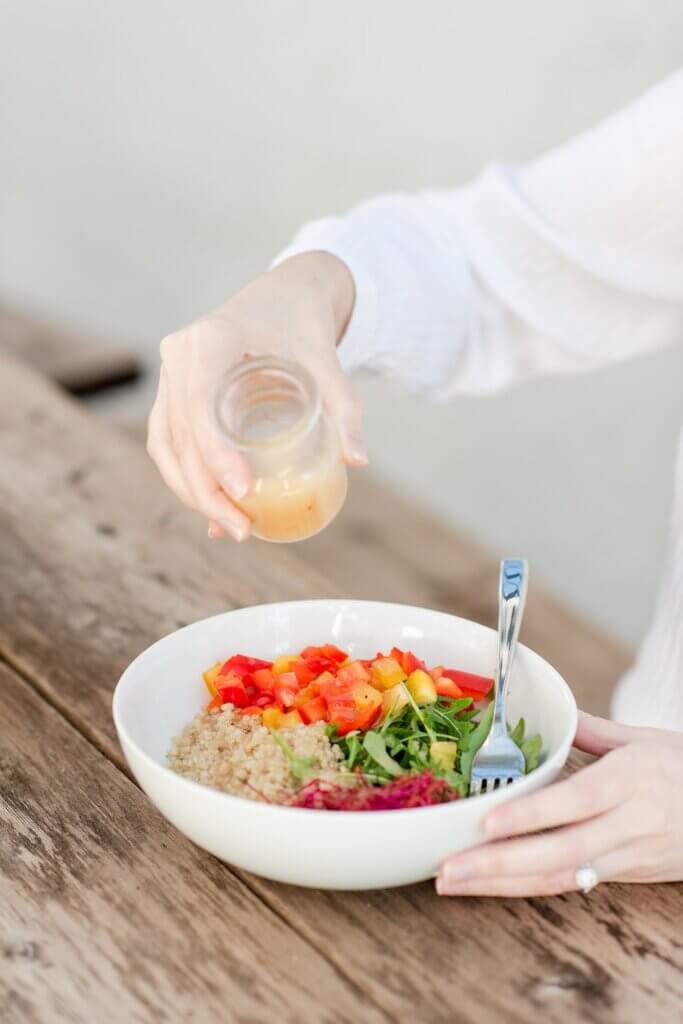 Food allergy travel agent eating a allergy friendly meal of fresh vegetables and rice.