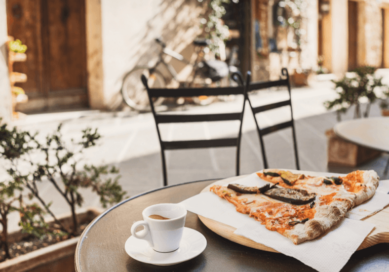 Eating with egg allergy in italy, enjoying an egg free pizza at cafe.